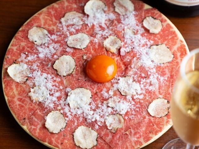 A yakiniku experience that showcases a selection of premium beef and optimal cooking methods tailored to each cut, offering a feast of beef-centric delights.