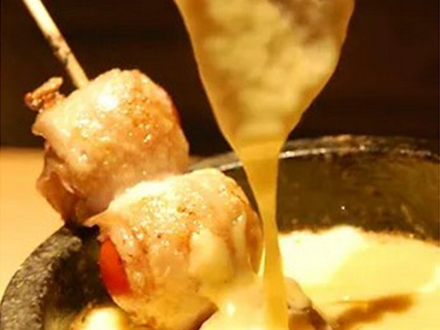 Cheese fondue with grilled chicken served at a hideaway with no curtain or sign