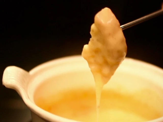 Enjoy the Swiss specialty cuisine Cheese Fondue along with various wines