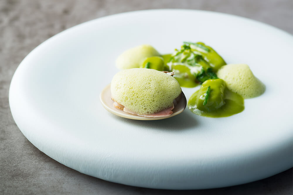 The lightly dashi-braised clams are topped with the bitter melon bubbles.